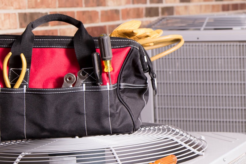 tool kit sitting on an AC unit